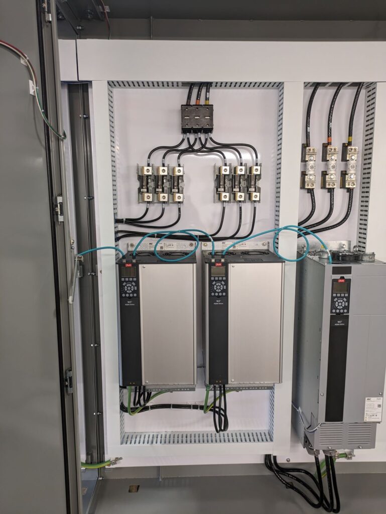 A panel displaying various electrical equipment and interconnected wires, showcasing a complex wiring system.